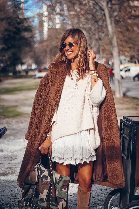 lace skirt and sweater that's layered by fur coats