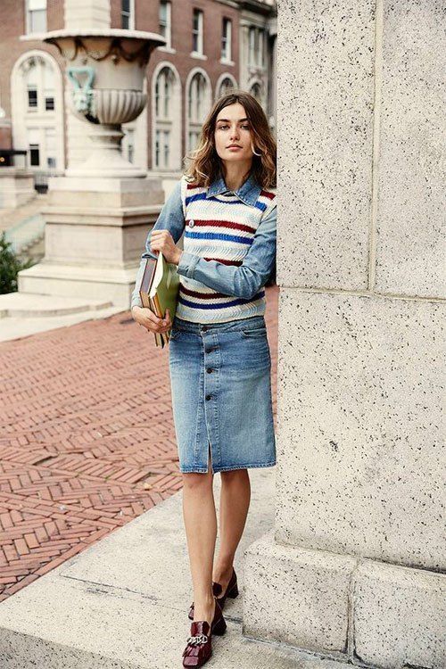 vasrsity style with denim and sweater vest outfit