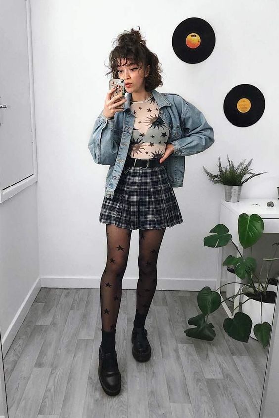 Plaid mini skirt, transparent top, and denim jacket to create grunge style