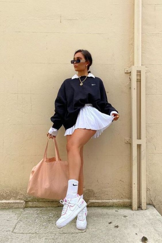 cute and trendy style in tennis skirt and sweater