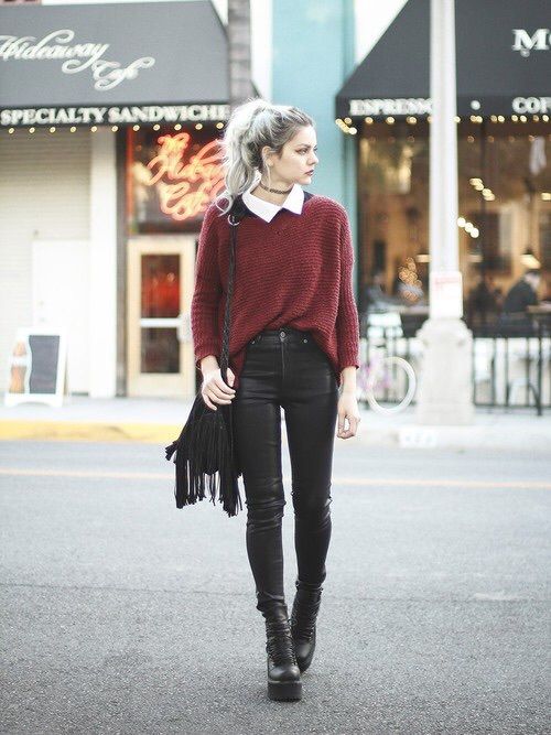 layering a collared shirt with the baggy sweater to turn out grunge style
