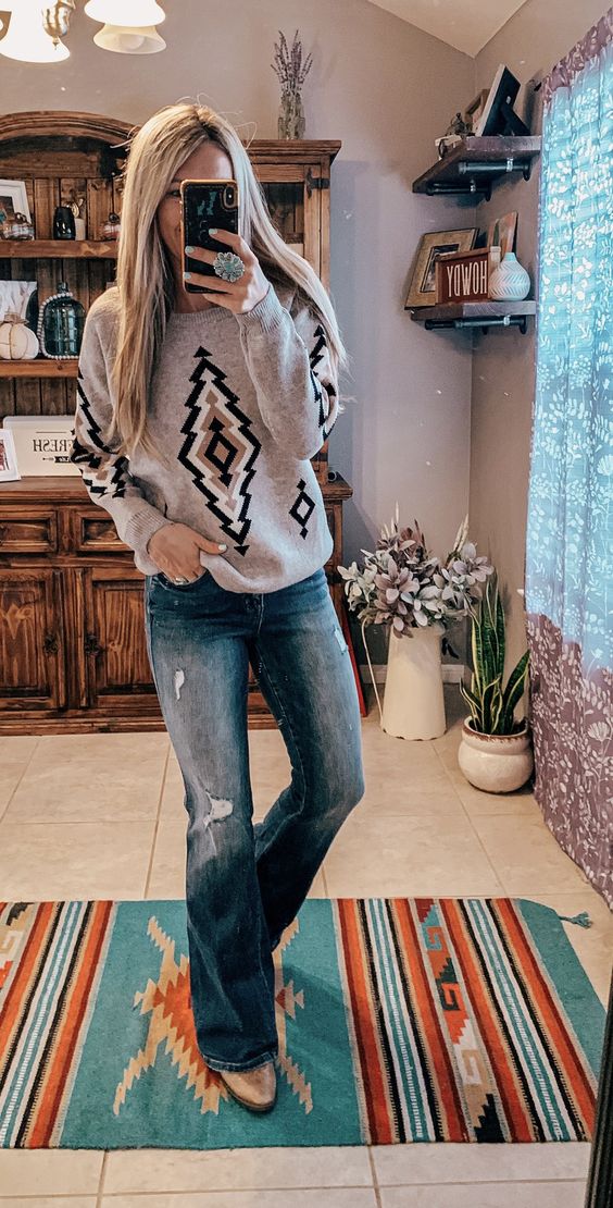 bootcut jeans with a bohemian pattern crewneck sweater
